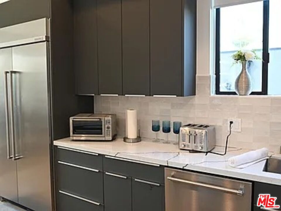 1410 Coronado Terrace Los Angeles, CA 90026 - Photo 5 of 27 a kitchen with appliances a sink and cabinets