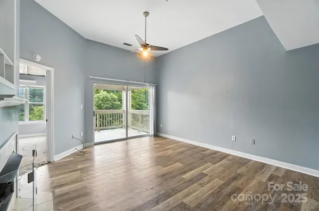 wooden floor fireplace and windows in an empty room
