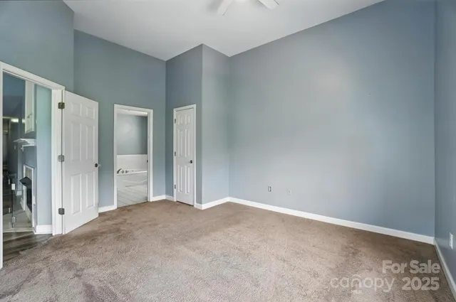 an empty room with closet and wooden floor