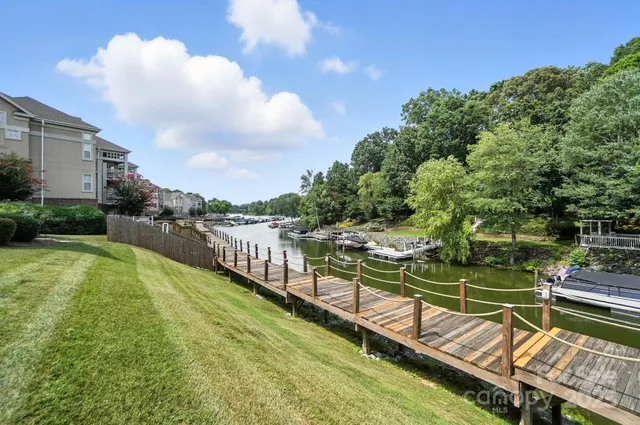 a view of a house with pool and a yard
