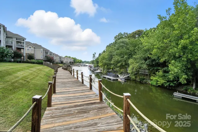 a view of a lake with a wooden deck