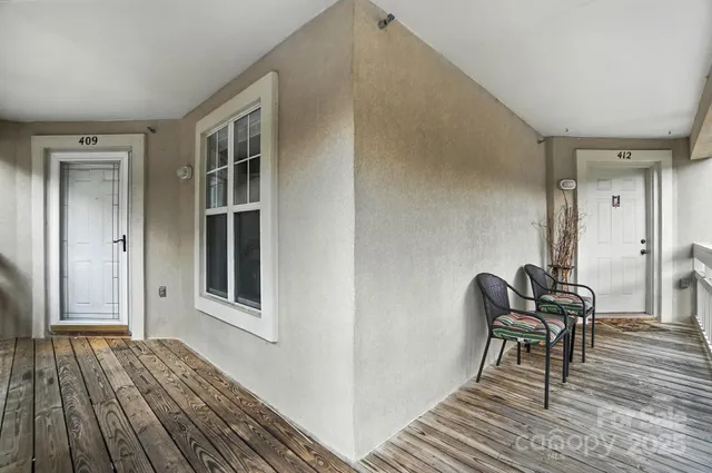 a view of a livingroom with furniture and lounge chair