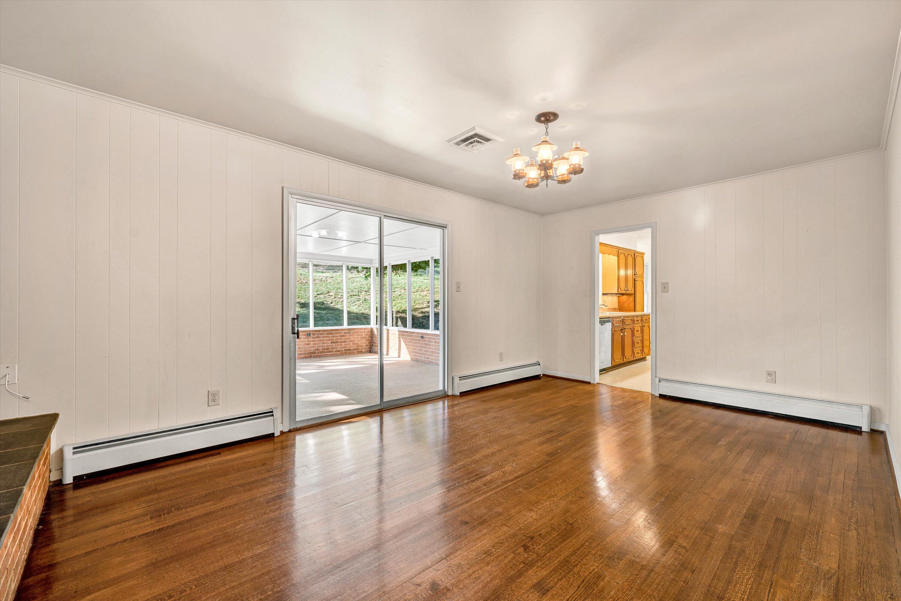 3008 Lofton Road Roanoke, VA 24018 - Photo 13 of 52 a view of an empty room with wooden floor and a window