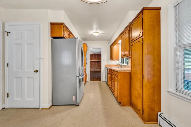 a bathroom with a granite countertop sink and a large mirror