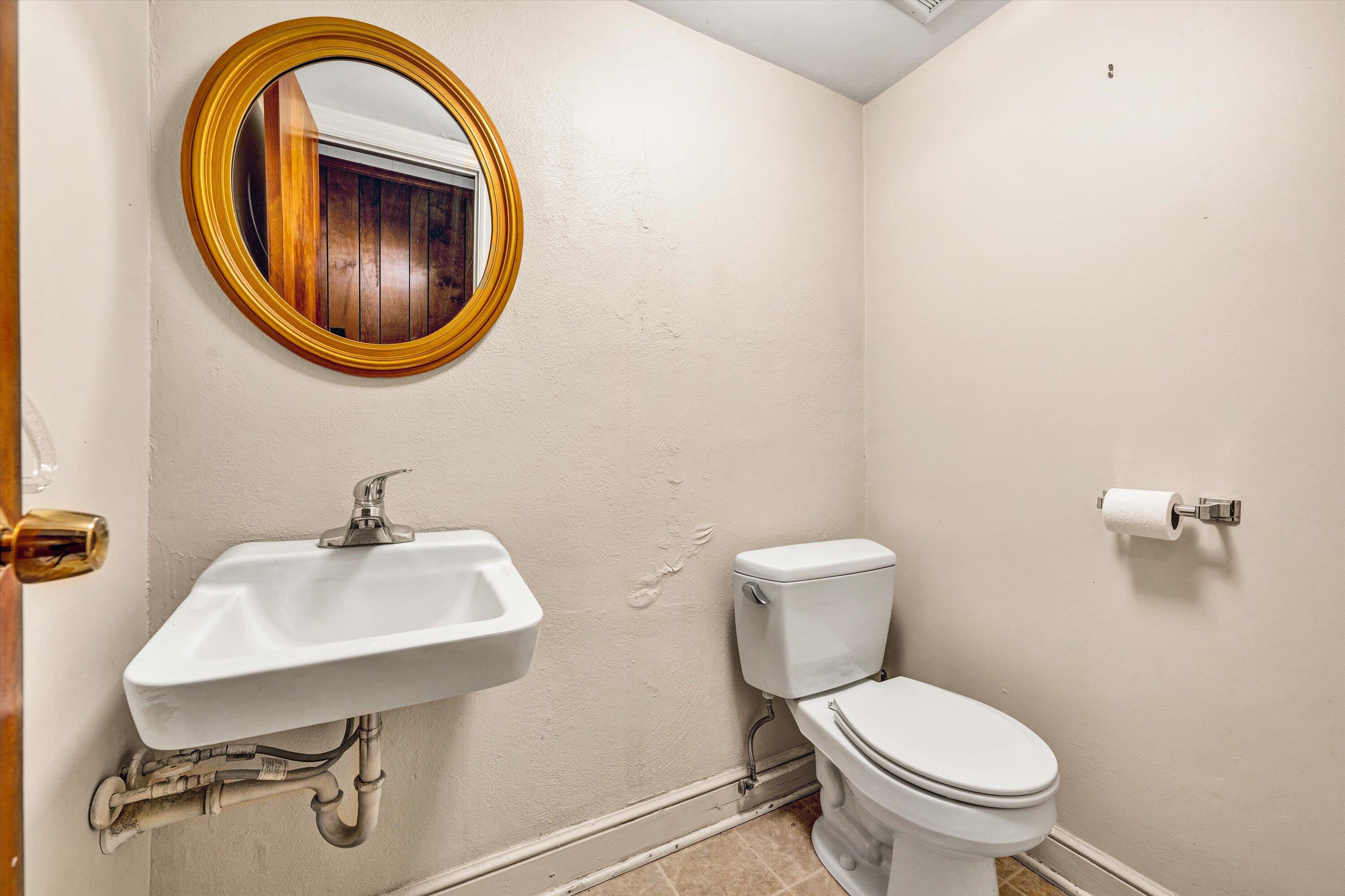 3008 Lofton Road Roanoke, VA 24018 - Photo 38 of 52 a bathroom with a sink mirror and toilet