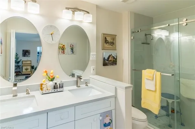 a bathroom with a sink mirror and toilet