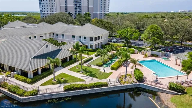 a front view of a house with a garden and swimming pool