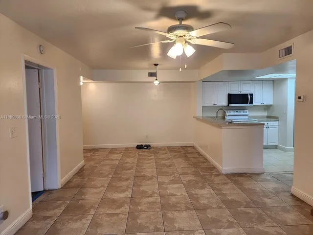a view of a kitchen with a sink cabinets and stainless steel appliances