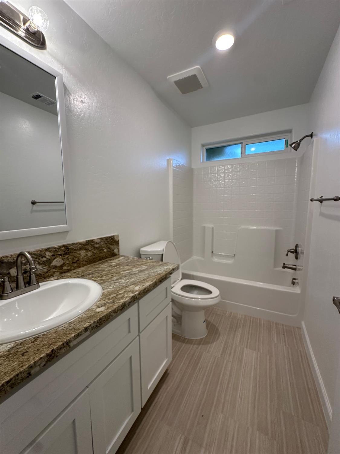 20568 Road 31 Madera, CA 93638 - Photo 15 of 24 a bathroom with a granite countertop sink toilet and shower
