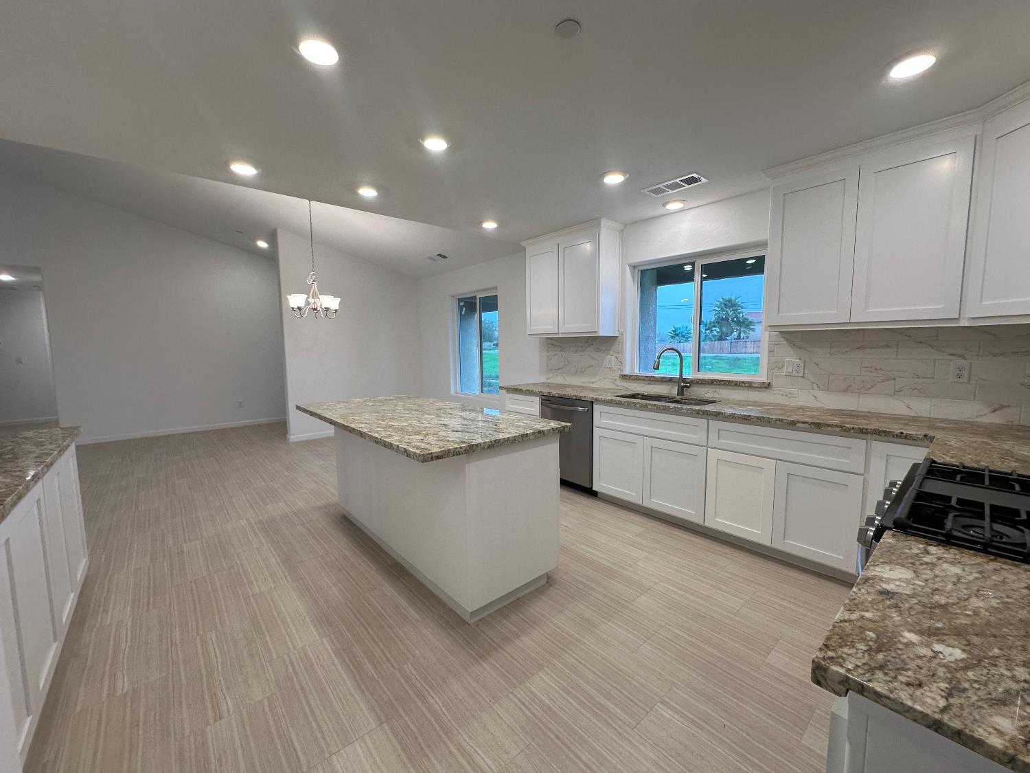 20568 Road 31 Madera, CA 93638 - Photo 5 of 24 a kitchen with a sink and white cabinets