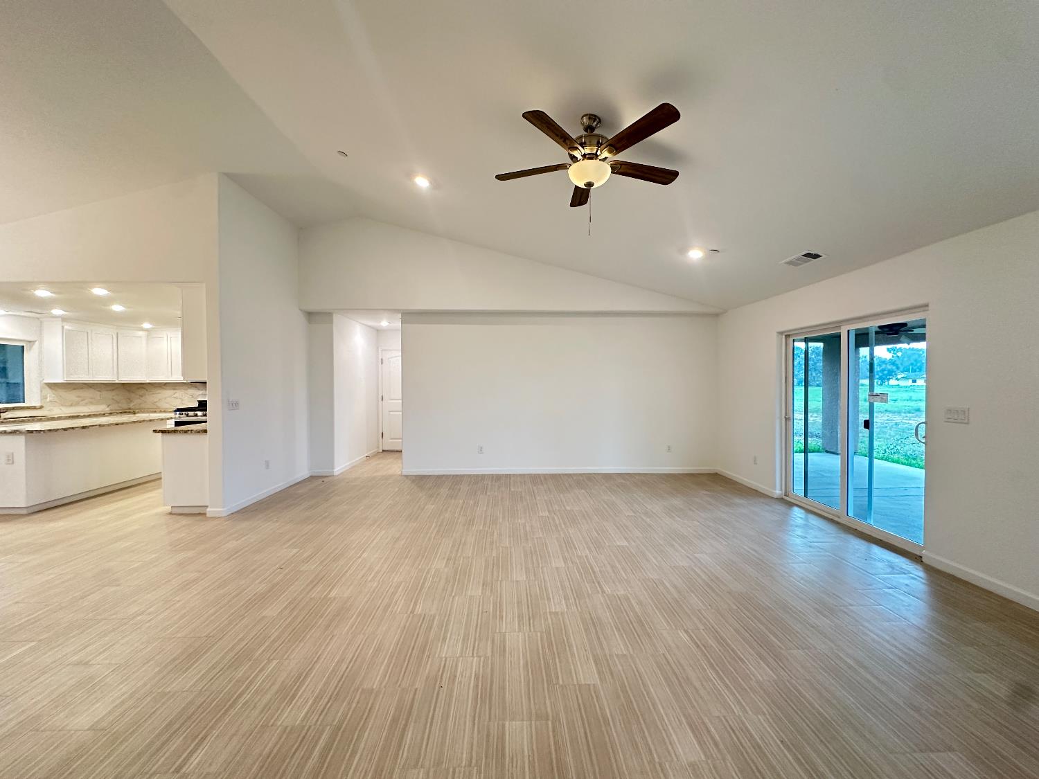 20568 Road 31 Madera, CA 93638 - Photo 8 of 24 a view of an empty room with wooden floor and a window