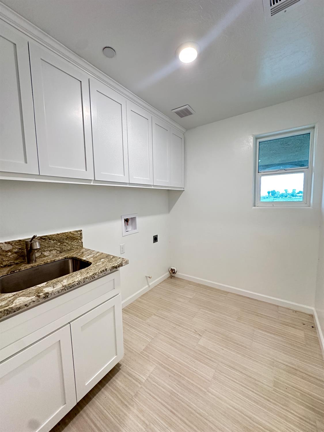 20568 Road 31 Madera, CA 93638 - Photo 10 of 24 a kitchen with granite countertop white cabinets and sink