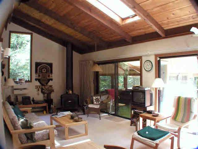 252 Fox Den Road Tolland, MA 01034 - Photo 4 of 6 a room with furniture a large window and a potted plant