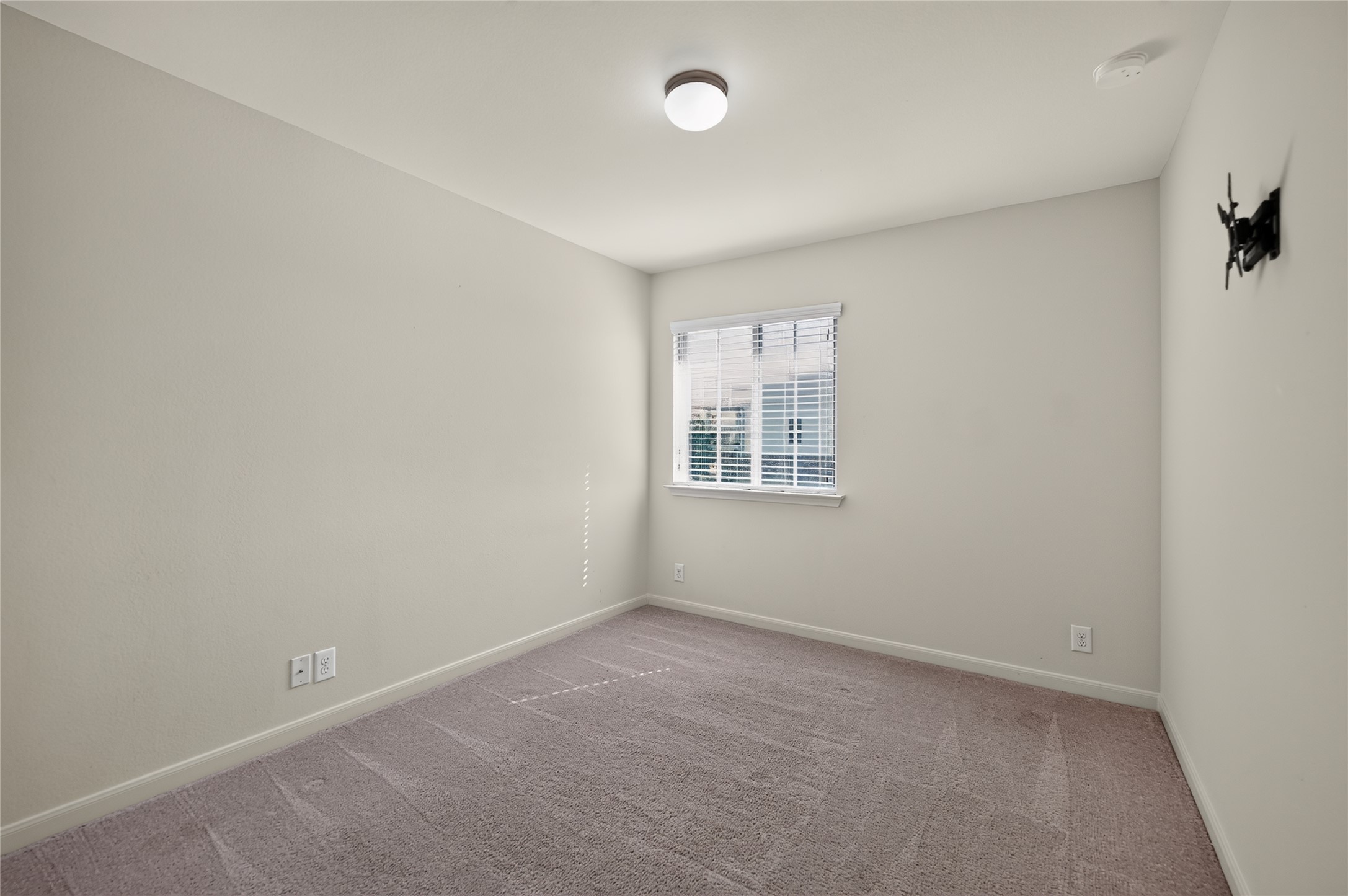 504 Old Peak Road Georgetown, TX 78626 - Photo 21 of 25 A well-lit bedroom features plush carpeting and a bright window with blinds.