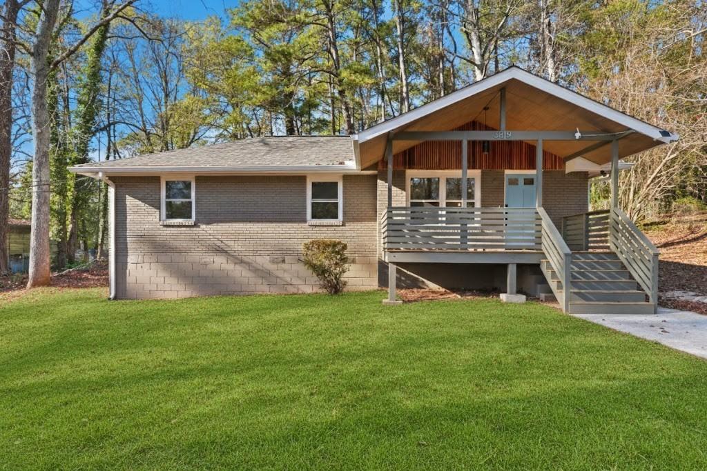 a front view of a house with a garden