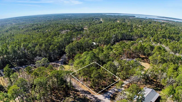 an aerial view of a residential houses with city view