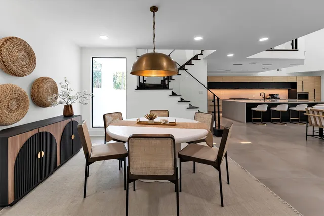 a dining room with furniture and wooden floor
