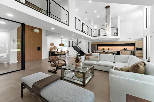 a living room with furniture and a chandelier