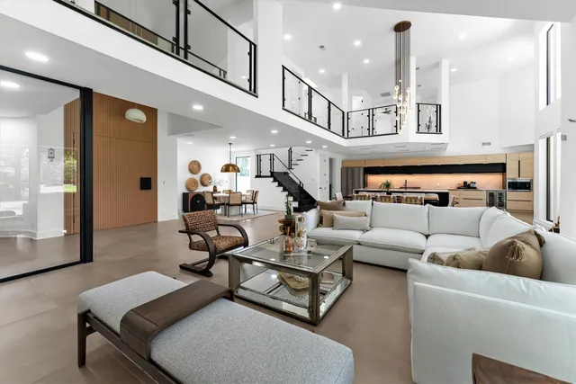 a living room with furniture and a chandelier