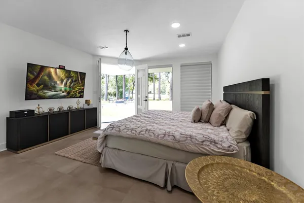 a bedroom with a bed and a flat screen tv
