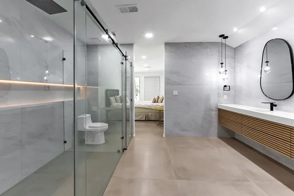 a bathroom with a double vanity sink toilet and shower