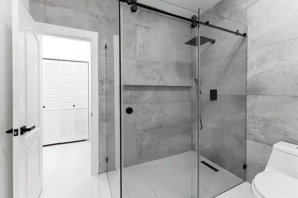 a bathroom with a shower and toilet