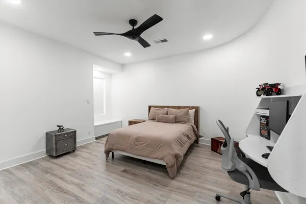 a bedroom with a bed a desk and chair