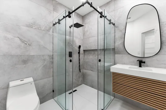 a bathroom with a sink toilet and shower