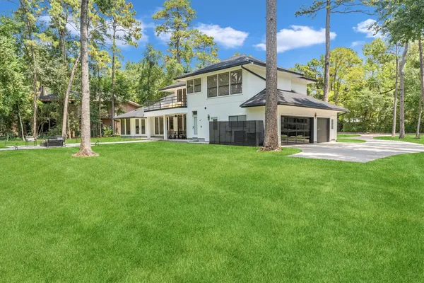a view of a house with a yard and sitting area