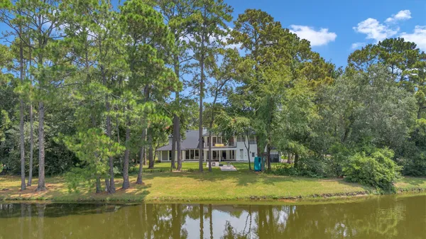 a view of a house with a yard and a garden