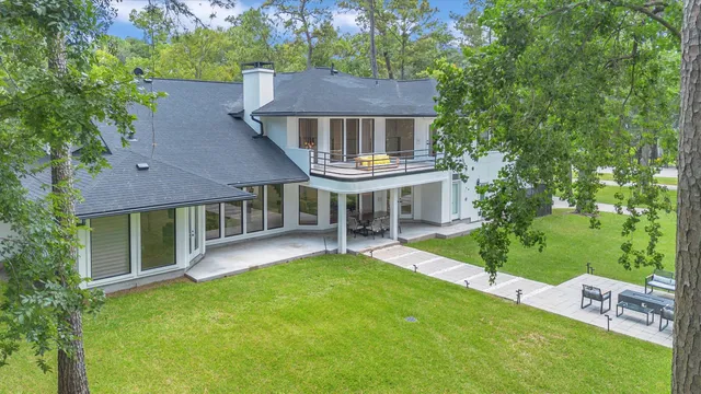 a aerial view of a house with a yard table and chairs