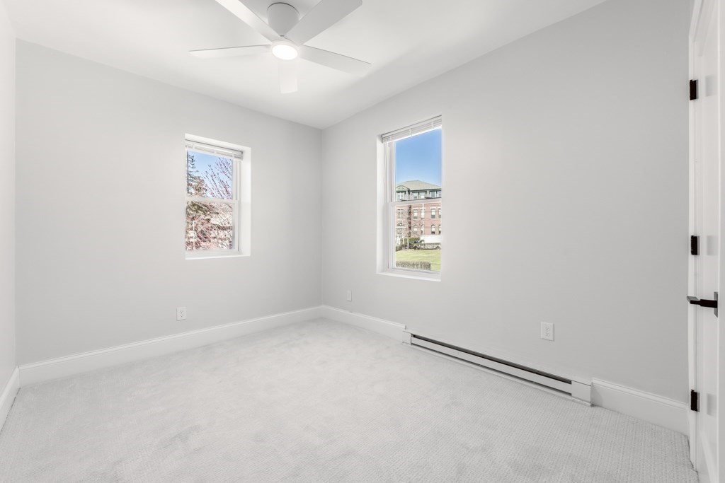 113 Regent Street Boston, MA 02119 - Photo 12 of 18 an empty room with windows and fan