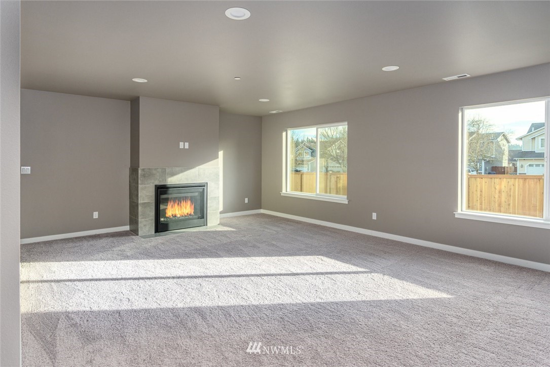 10503 Angeline Road East Bonney Lake, WA 98391 - Photo 14 of 38 an empty room with windows and fireplace