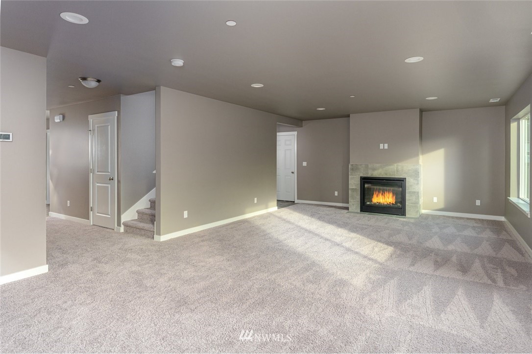 10503 Angeline Road East Bonney Lake, WA 98391 - Photo 15 of 38 an empty room with fireplace and a window