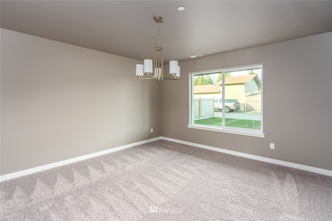 10503 Angeline Road East Bonney Lake, WA 98391 - Photo 17 of 38 an empty room with windows and outdoor view