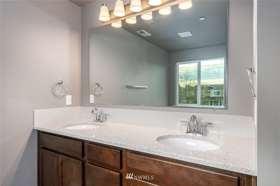 10503 Angeline Road East Bonney Lake, WA 98391 - Photo 23 of 38 a bathroom with a sink double vanity and a mirror