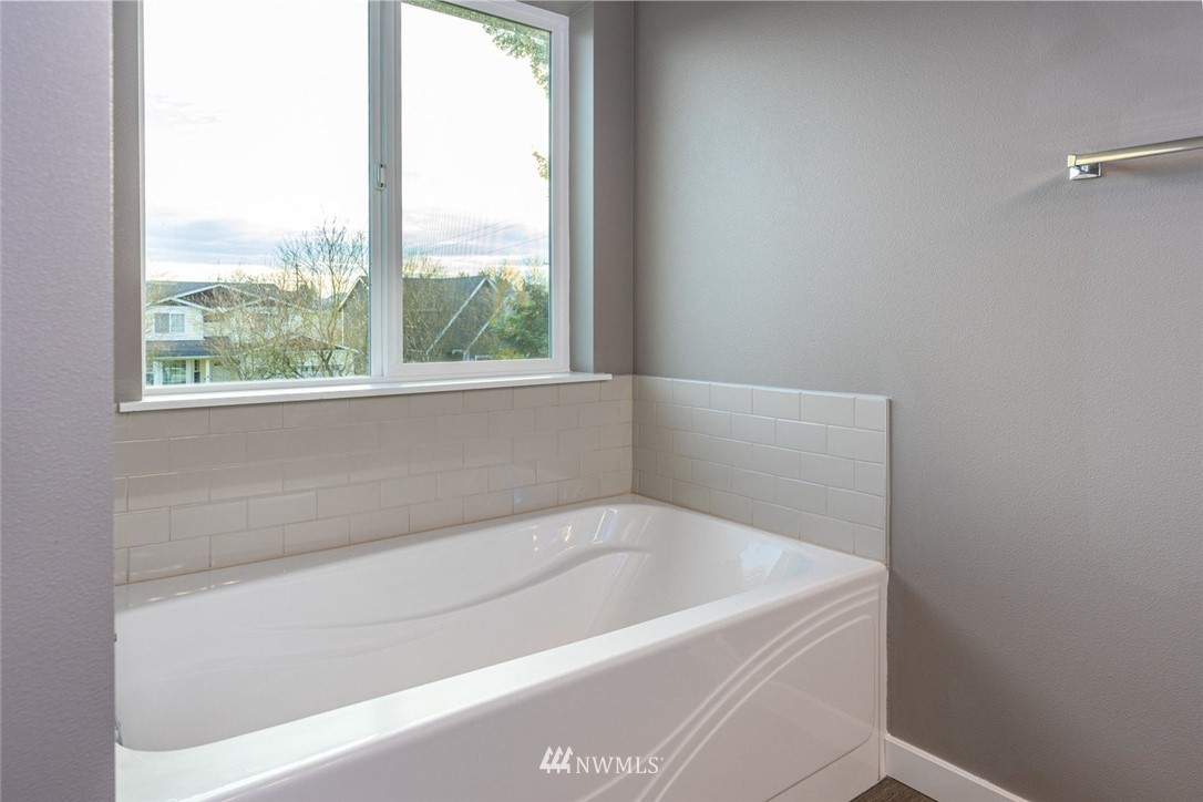 10503 Angeline Road East Bonney Lake, WA 98391 - Photo 24 of 38 a white bath tub sitting next to a window