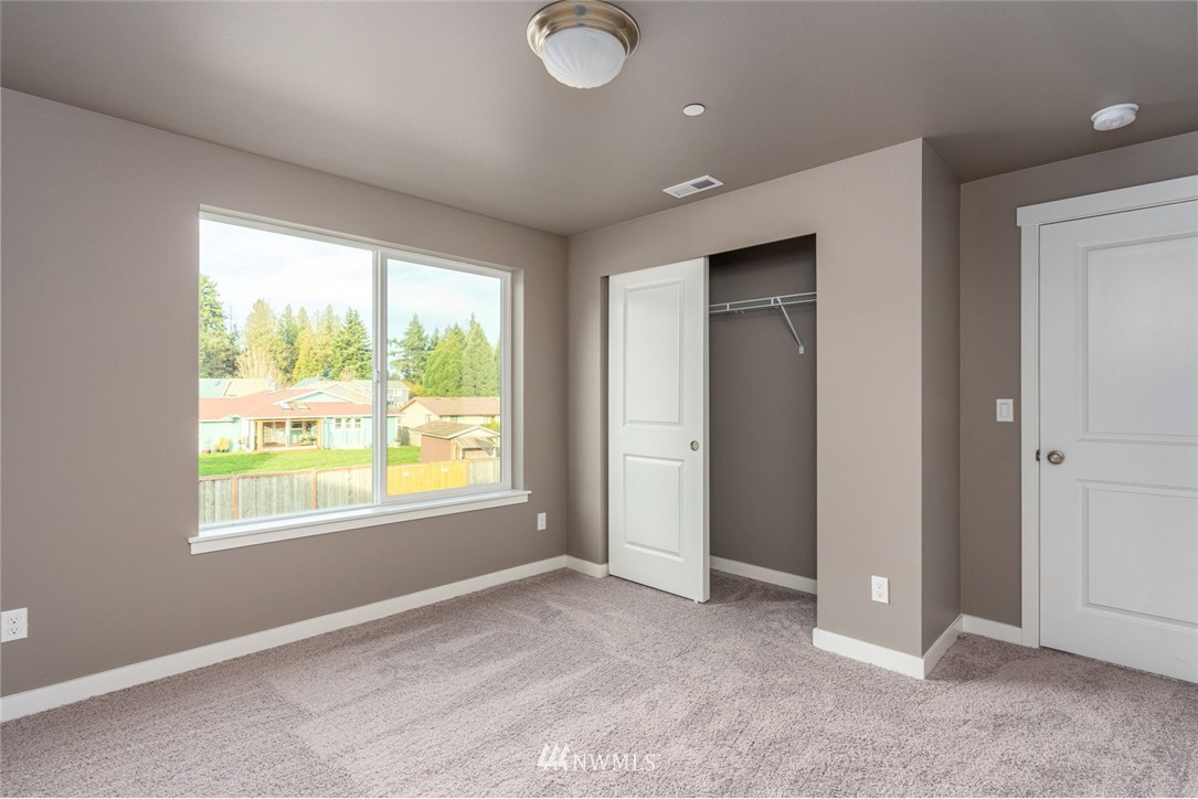 10503 Angeline Road East Bonney Lake, WA 98391 - Photo 27 of 38 a view of an empty room with a window