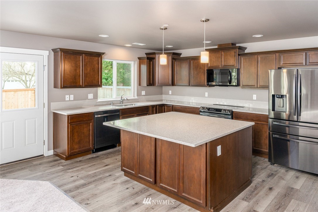 10503 Angeline Road East Bonney Lake, WA 98391 - Photo 8 of 38 a kitchen with stainless steel appliances granite countertop a sink stove and refrigerator