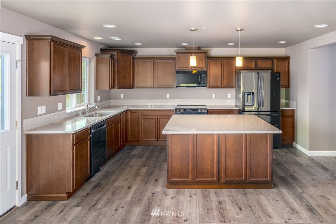 10503 Angeline Road East Bonney Lake, WA 98391 - Photo 9 of 38 a kitchen with a sink cabinets and wooden floor