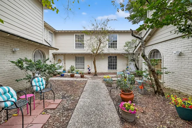 a front view of a house with sitting area