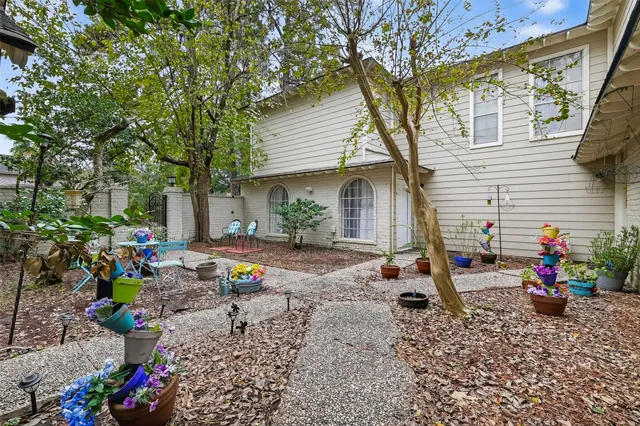 a view of a chairs and table in the backyard