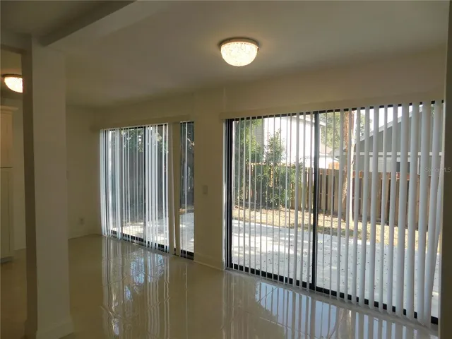 a view of empty room with floor to ceiling window