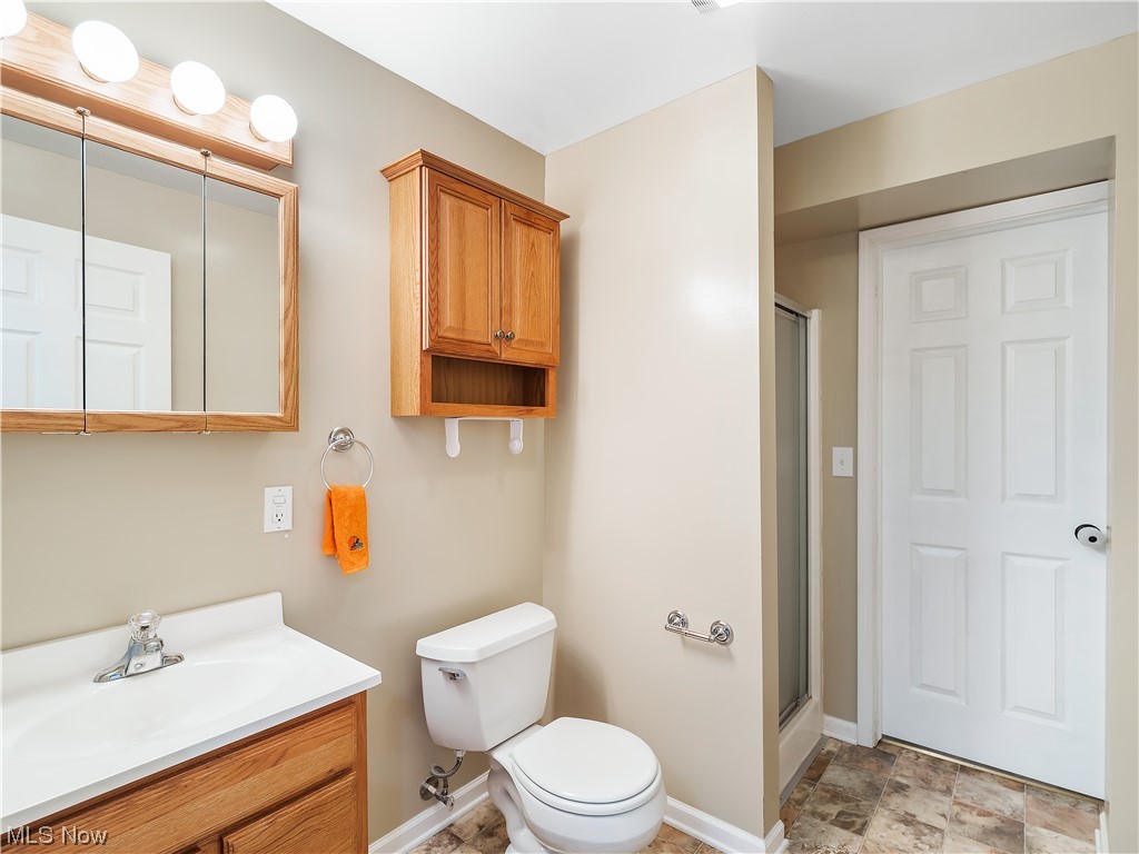 5319 Otten Road North Ridgeville, OH 44039 - Photo 26 of 33 Bathroom featuring an enclosed shower, vanity, mirror, and light tile floors