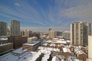 1221 North Dearborn Parkway, Unit 1601N Chicago, IL 60610 - Photo 2 of 21 a living room with furniture a fireplace and city view