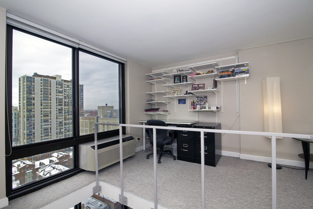 1221 North Dearborn Parkway, Unit 1601N Chicago, IL 60610 - Photo 12 of 21 a room with furniture a window and a fireplace