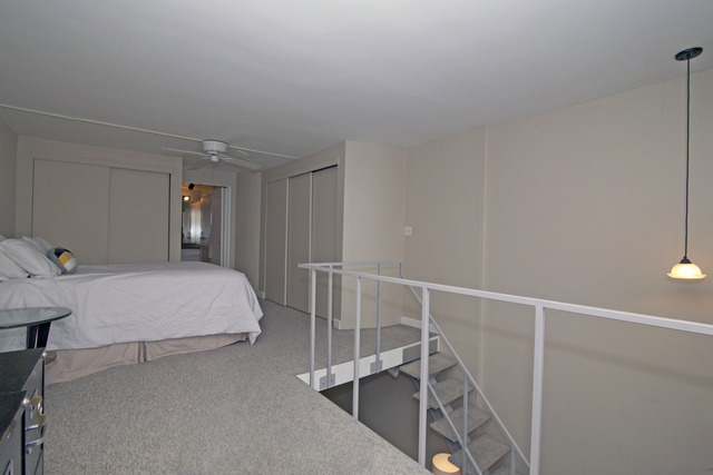 1221 North Dearborn Parkway, Unit 1601N Chicago, IL 60610 - Photo 18 of 21 a bedroom with a bed and a table in it