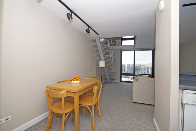 1221 North Dearborn Parkway, Unit 1601N Chicago, IL 60610 - Photo 5 of 21 a dining room with furniture and window