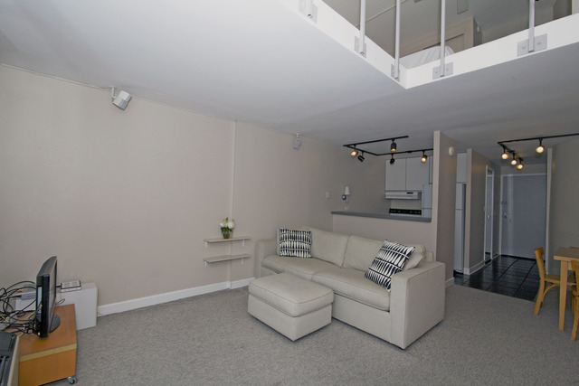 1221 North Dearborn Parkway, Unit 1601N Chicago, IL 60610 - Photo 8 of 21 a spacious bedroom with a bed a couch and a chandelier