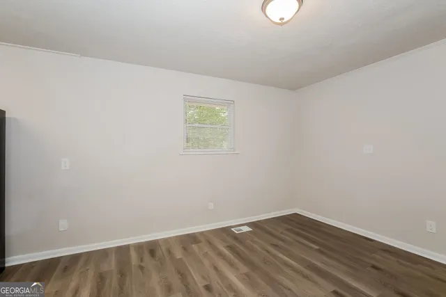 a kitchen with a refrigerator a stove top oven a counter space and cabinets